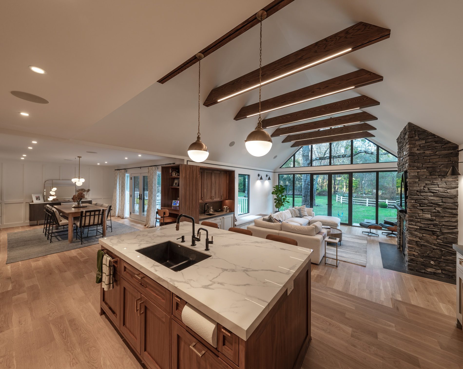 Open-plan kitchen and vaulted great room completed by Home Evolutions Corp in Greenwich, Connecticut.
